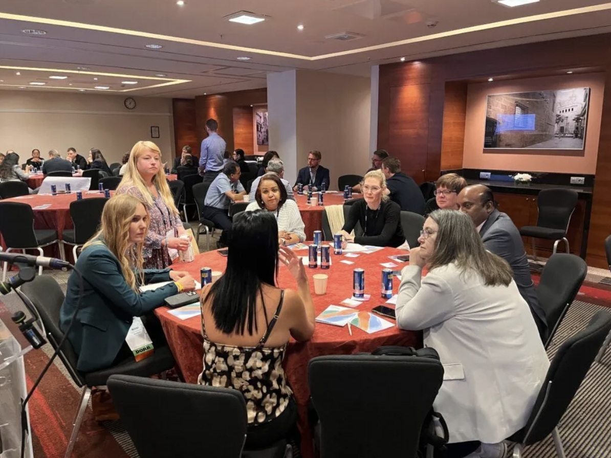 A group of people sitting at a round table.